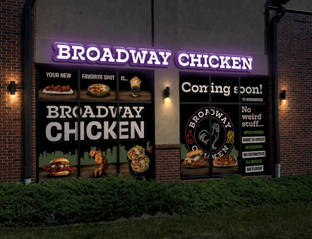 Illuminated storefront at night with coming-soon window graphics