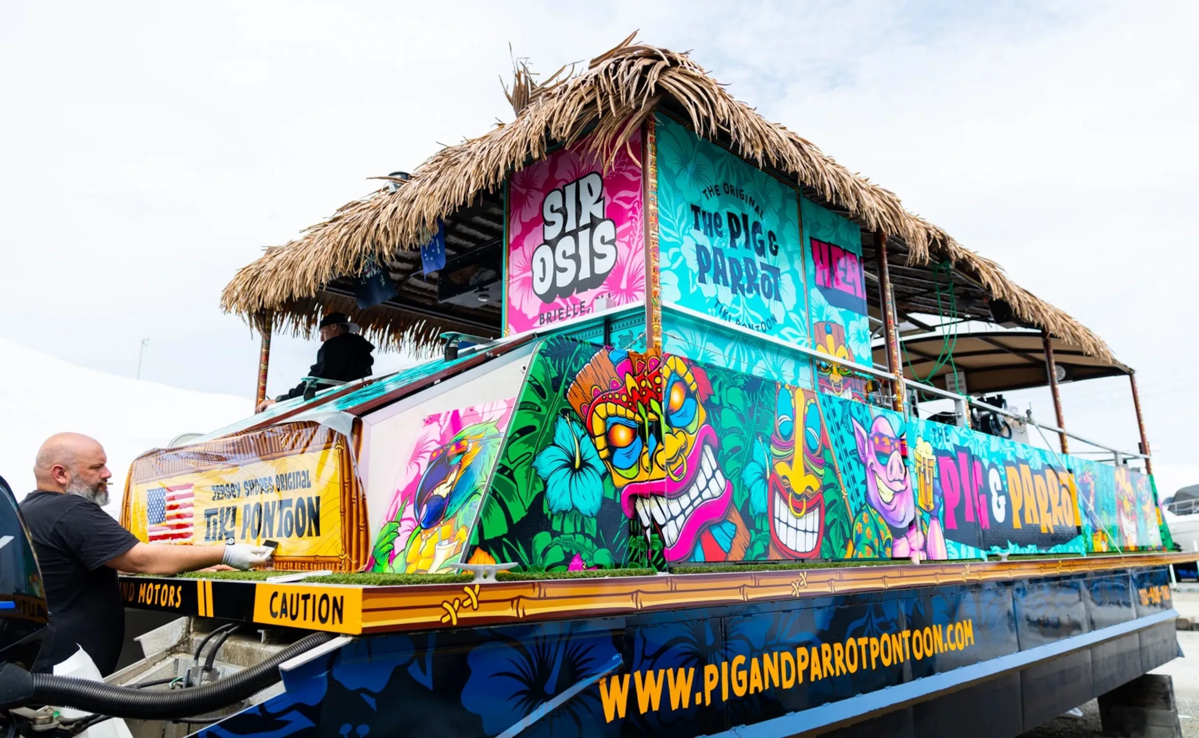 The wrapped Pig & Parrot tiki pontoon moored on the water